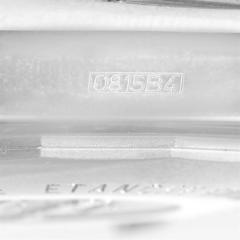 The image shows a close-up of the serial number engraved inside the case of a Breitling Chronomat CB0110 Men's Steel and Gold (two tone) Black Dial CB0110 Men's Steel and Gold (two tone) Black Dial watch.
