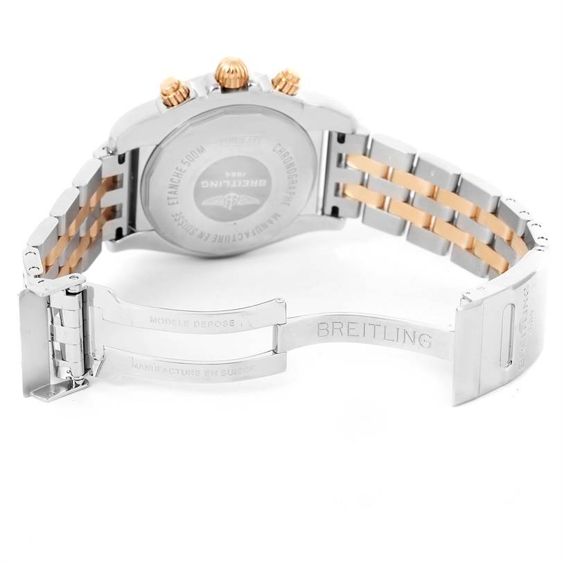 The image shows the backside of a Breitling Chronomat CB0110 Men's Steel and Gold (two tone) Black Dial CB0110 Men's Steel and Gold (two tone) Black Dial watch, highlighting its clasp, band, and back case.