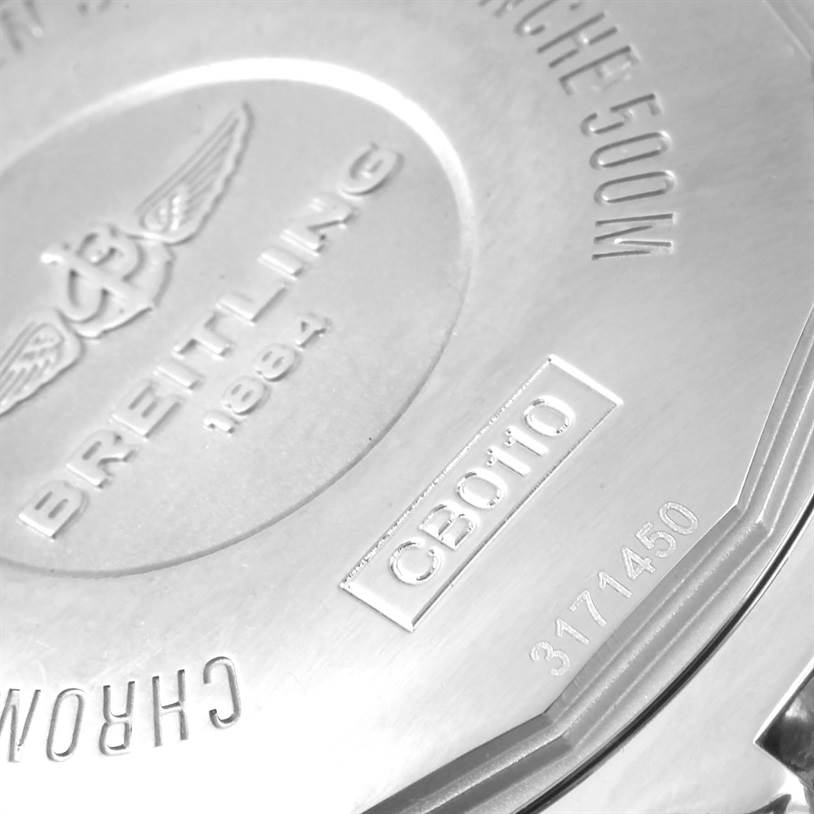 The image shows the back case of a Breitling Chronomat CB0110 Men's Steel and Gold (two tone) Black Dial CB0110 Men's Steel and Gold (two tone) Black Dial watch, labeled with model information and specifications.