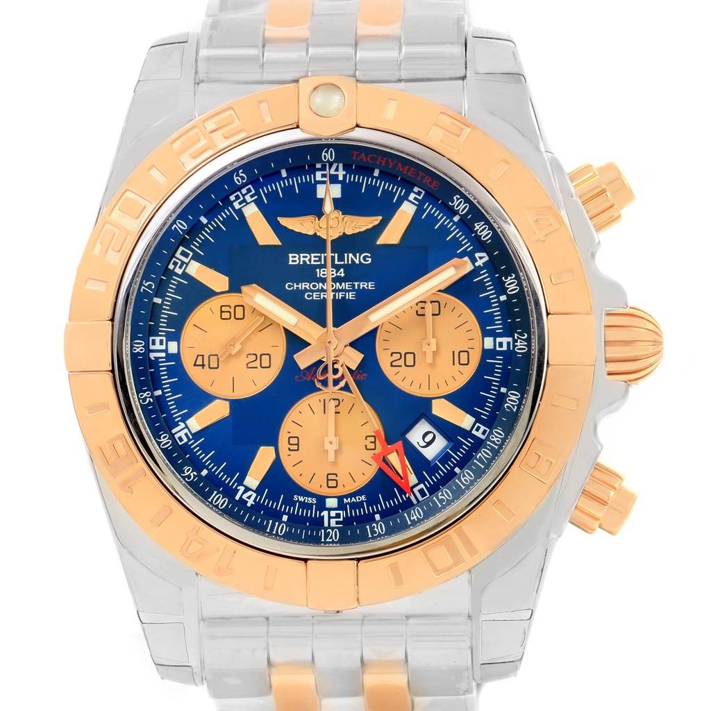The image shows a close-up of the Breitling Chronomat CB042012/C858 Men's Steel and Gold (two tone) Blue Dial CB042012/C858 Men's Steel and Gold (two tone) Blue Dial watch face and part of the band, highlighting its dials, bezel, and side buttons.