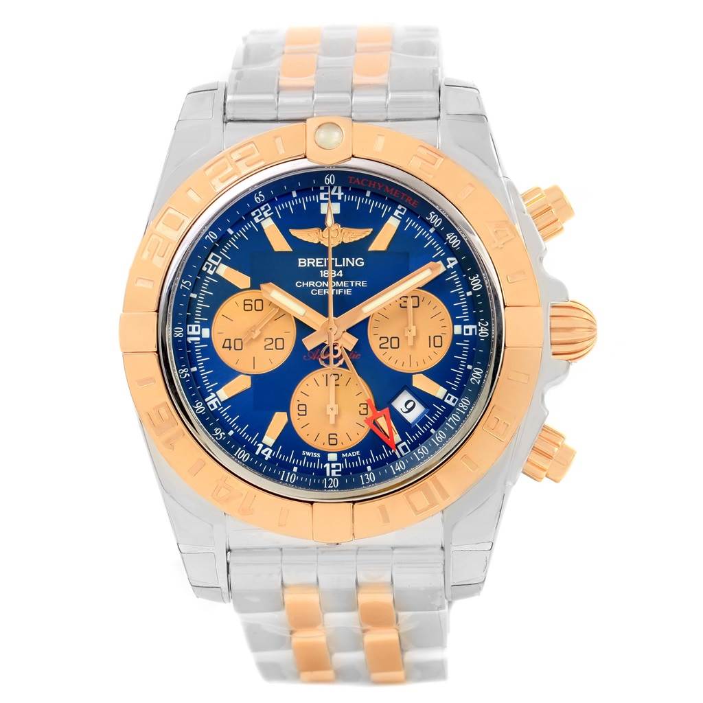 The image shows a frontal view of a Breitling Chronomat CB042012/C858 Men's Steel and Gold (two tone) Blue Dial CB042012/C858 Men's Steel and Gold (two tone) Blue Dial watch, highlighting its blue dial, gold accents, and two-tone bracelet.