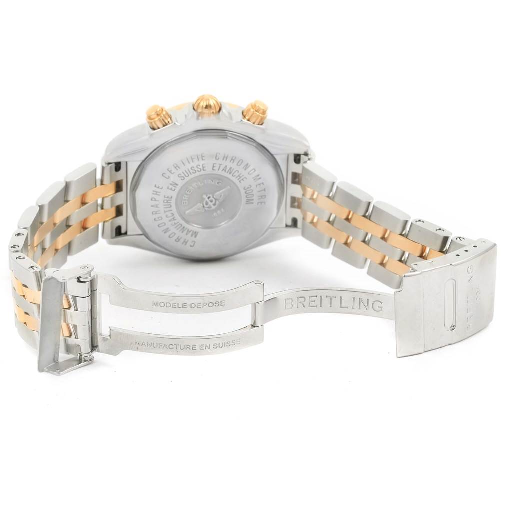 The image shows the back case and open clasp of a Breitling Chronomat C13356 Men's Steel and Gold (two tone) White Dial C13356 Men's Steel and Gold (two tone) White Dial watch with a two-tone metal bracelet.
