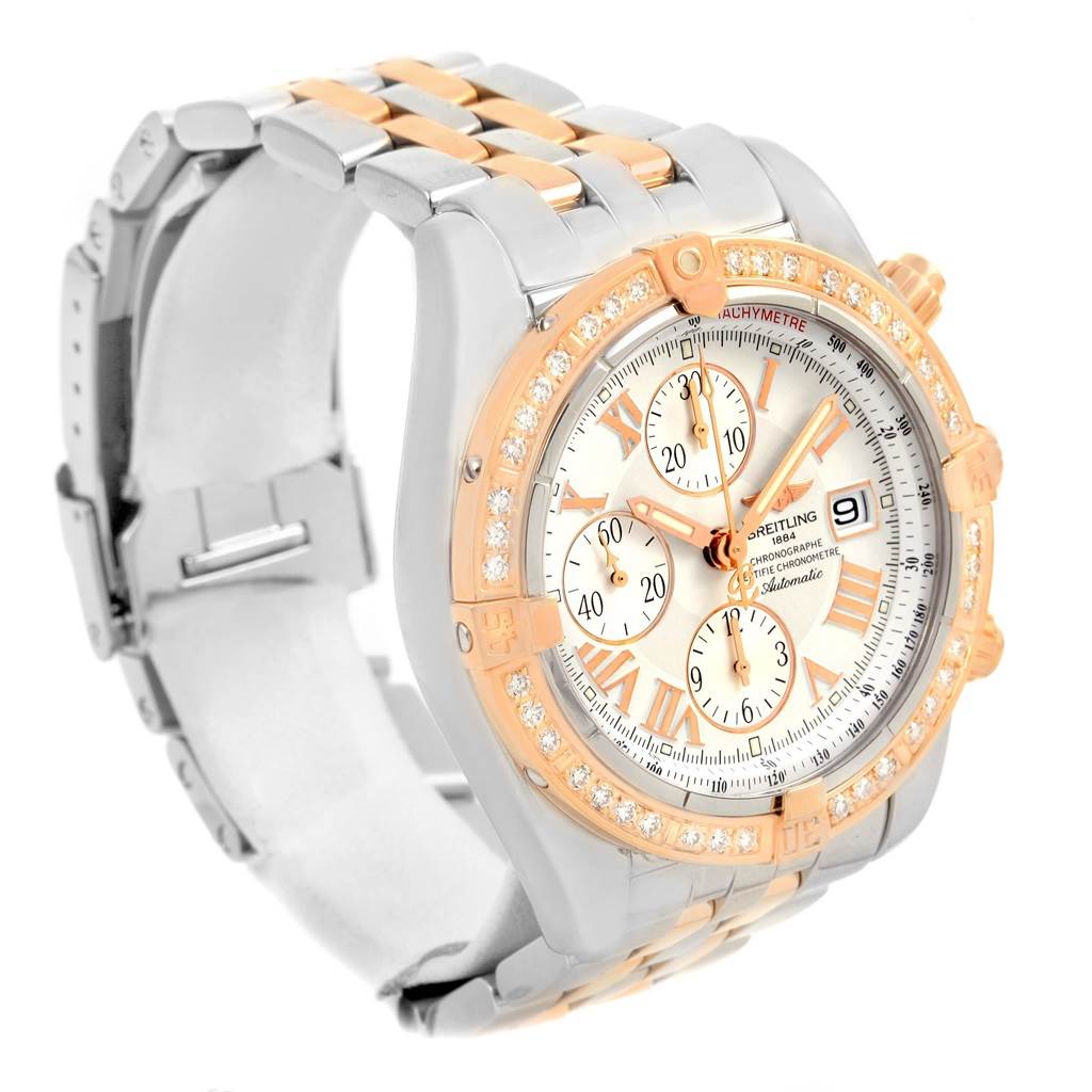 The image shows the front and part of the bracelet of the Breitling Chronomat C13356 Men's Steel and Gold (two tone) White Dial C13356 Men's Steel and Gold (two tone) White Dial watch, highlighting its dial, bezel, and band.
