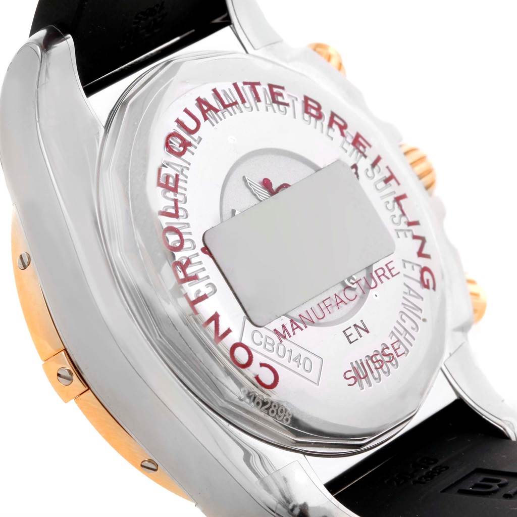 The image shows the back case and strap attachment of a Breitling Chronomat CB0140 Men's Steel and Gold (two tone) Black Dial CB0140 Men's Steel and Gold (two tone) Black Dial watch, highlighting inscriptions and serial numbers.