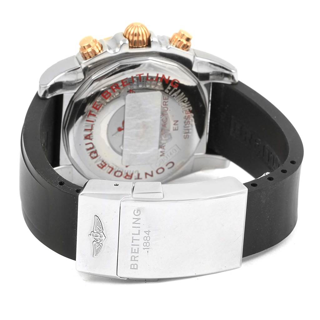 The image shows the back of a Breitling Chronomat CB0140 Men's Steel and Gold (two tone) Black Dial CB0140 Men's Steel and Gold (two tone) Black Dial watch, focusing on the clasp and the case back.
