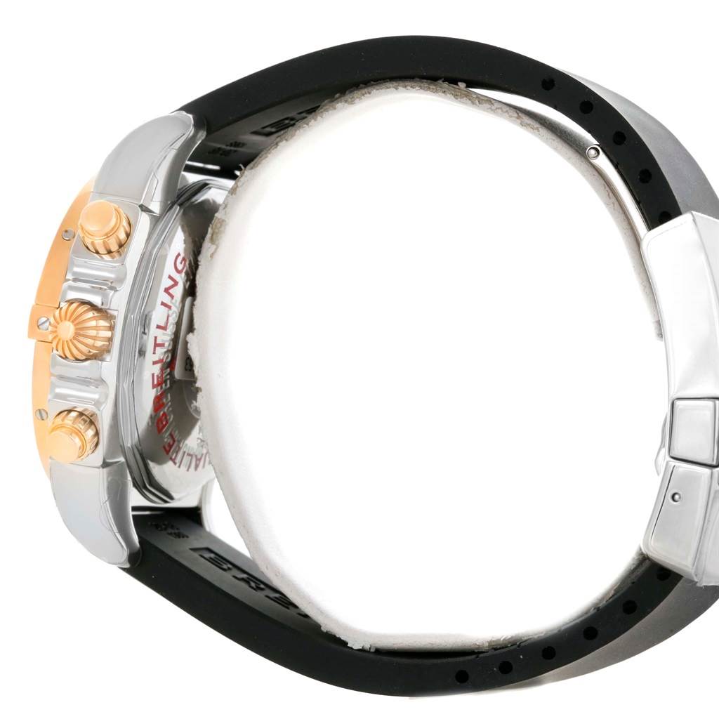 The image shows the side angle of the Breitling Chronomat CB0140 Men's Steel and Gold (two tone) Black Dial CB0140 Men's Steel and Gold (two tone) Black Dial watch, highlighting the crown, pushers, and part of the black strap.