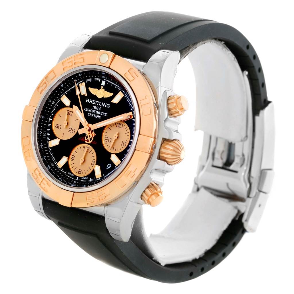 The Breitling Chronomat CB0140 Men's Steel and Gold (two tone) Black Dial CB0140 Men's Steel and Gold (two tone) Black Dial watch is shown from a three-quarter angle, highlighting the dial, bezel, and rubber strap.