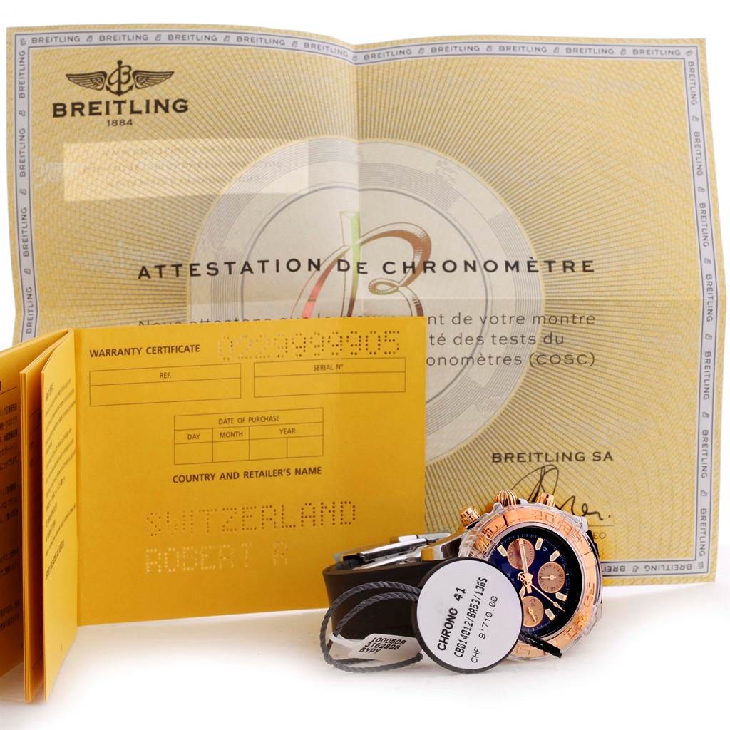 The image shows the Breitling Chronomat CB0140 Men's Steel and Gold (two tone) Black Dial CB0140 Men's Steel and Gold (two tone) Black Dial watch with its certificates and warranty card.