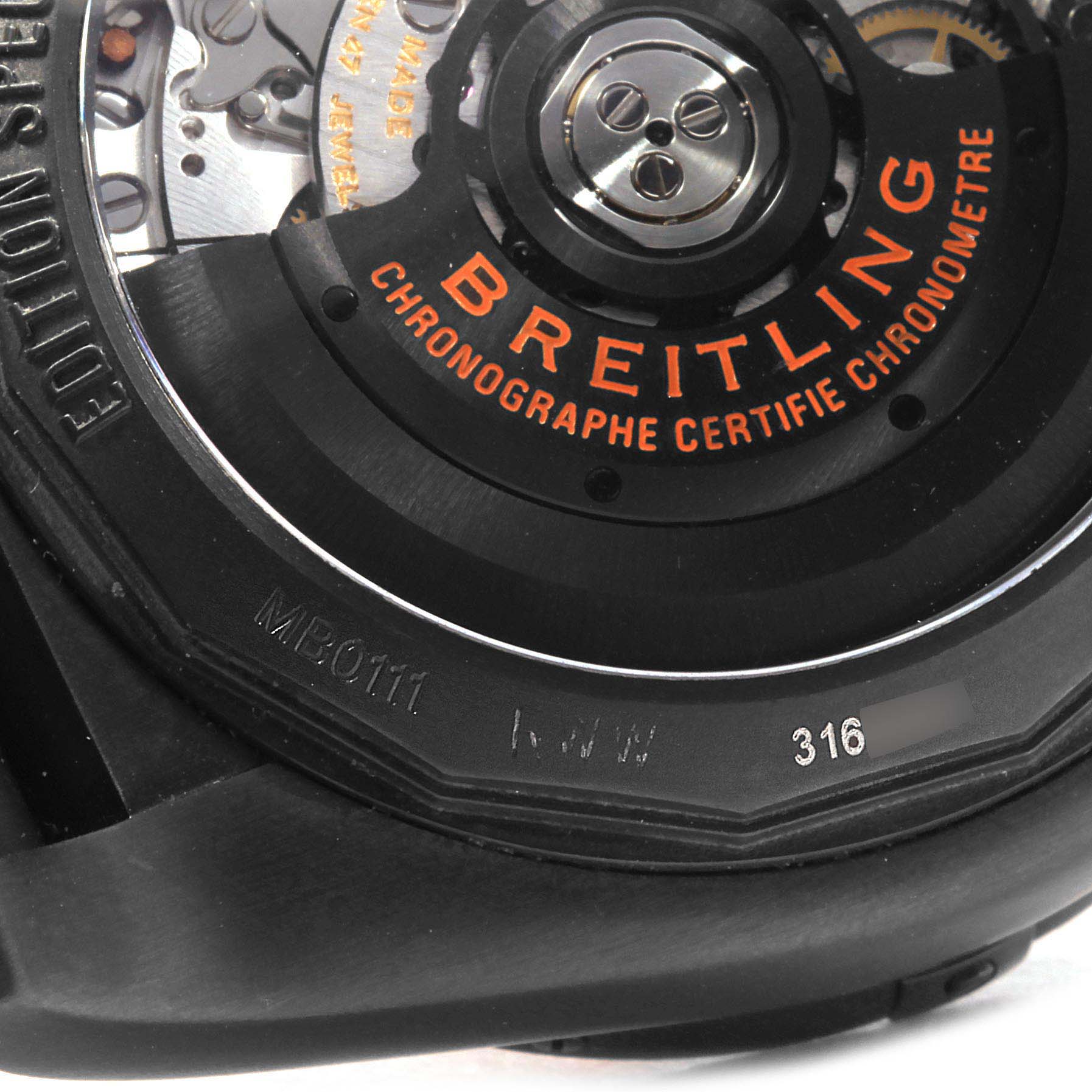 This image shows the back of a Breitling Chronomat MB0111C2/BD07/153S Men's Stainless Steel Black Dial MB0111C2/BD07/153S Men's Stainless Steel Black Dial watch, highlighting the rotor mechanism and engraved markings.