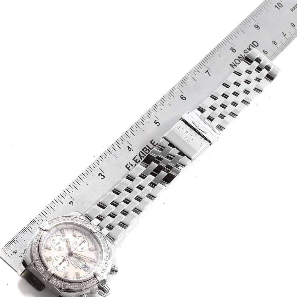 The image shows a Breitling Chronomat A13356 Men's Stainless Steel Mother of Pearl Dial A13356 Men's Stainless Steel Mother of Pearl Dial watch with its bracelet and clasp, alongside a ruler measuring the length.