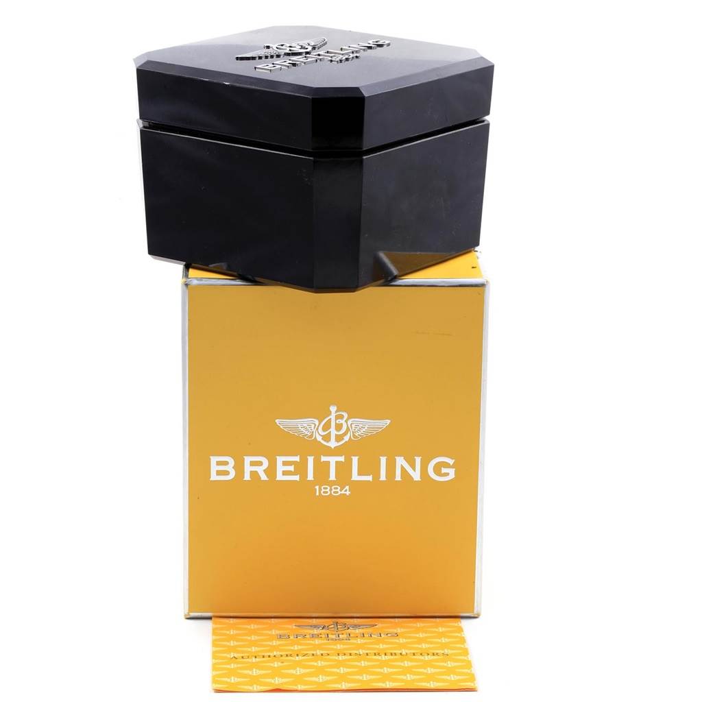 The image shows the packaging for a Breitling Chronomat CB014012 Men
s Steel and Gold (two tone) Silver Dial CB014012 Men
s Steel and Gold (two tone) Silver Dial watch, including a black presentation box, a yellow box, and a warranty card.