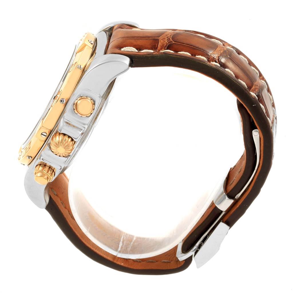 The image shows a side view of a Breitling Chronomat CB014012 Men
s Steel and Gold (two tone) Silver Dial CB014012 Men
s Steel and Gold (two tone) Silver Dial watch with a brown leather strap and gold accents on the case.