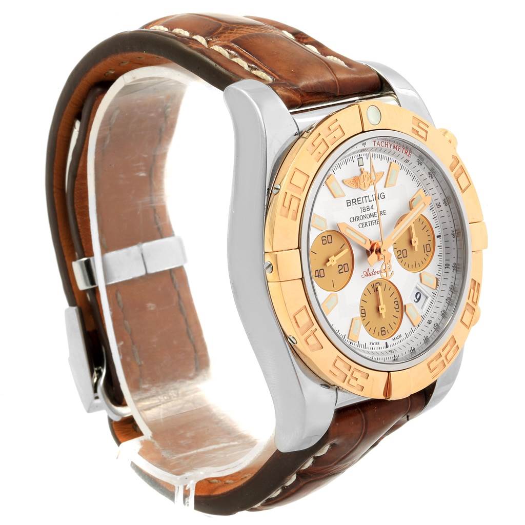 The Breitling Chronomat CB014012 Men
s Steel and Gold (two tone) Silver Dial CB014012 Men
s Steel and Gold (two tone) Silver Dial watch is shown at a front-side angle, displaying the bezel, dial, and leather strap.