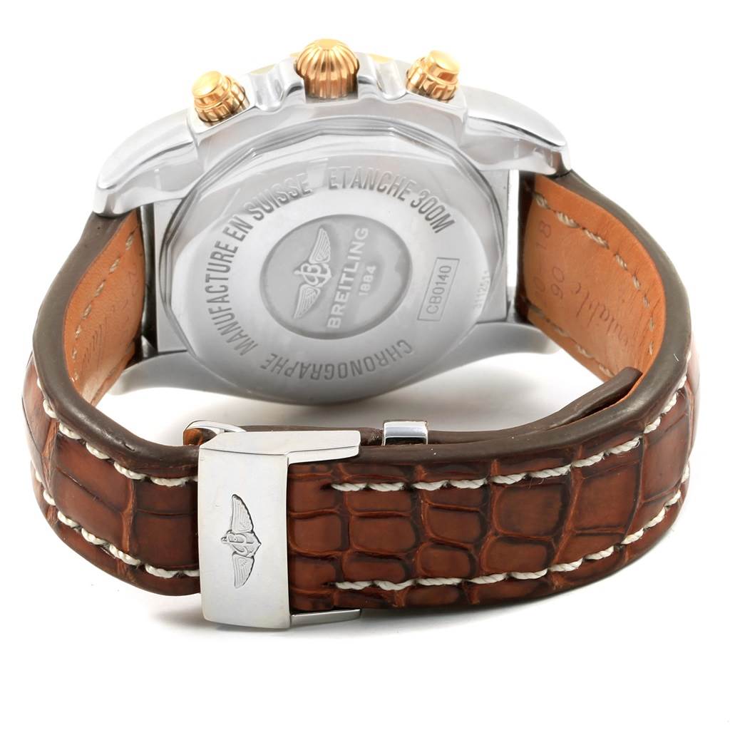 This image shows the back view of a Breitling Chronomat CB014012 Men
s Steel and Gold (two tone) Silver Dial CB014012 Men
s Steel and Gold (two tone) Silver Dial watch, showcasing its case back and brown leather strap.