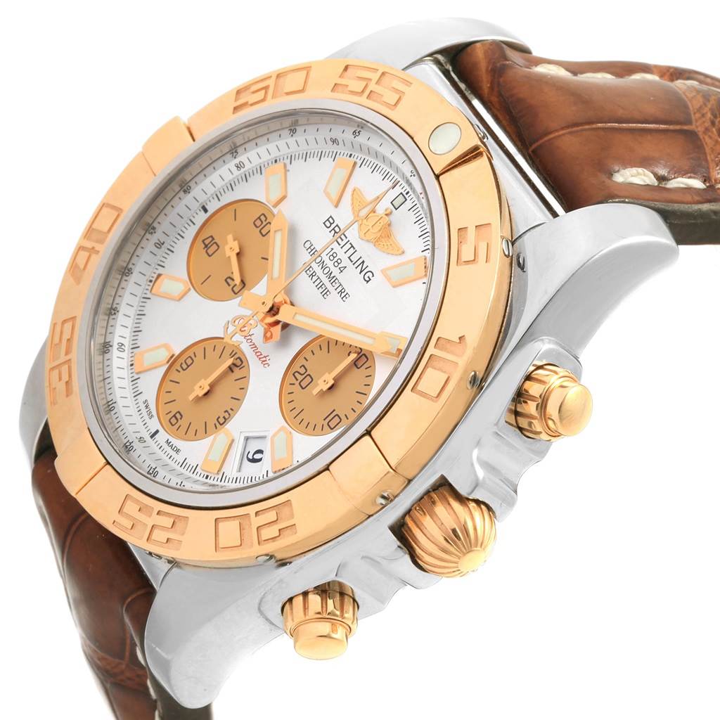 The image shows a Breitling Chronomat CB014012 Men
s Steel and Gold (two tone) Silver Dial CB014012 Men
s Steel and Gold (two tone) Silver Dial watch from a side angle, displaying the gold bezel, chronograph buttons, and part of the leather strap.