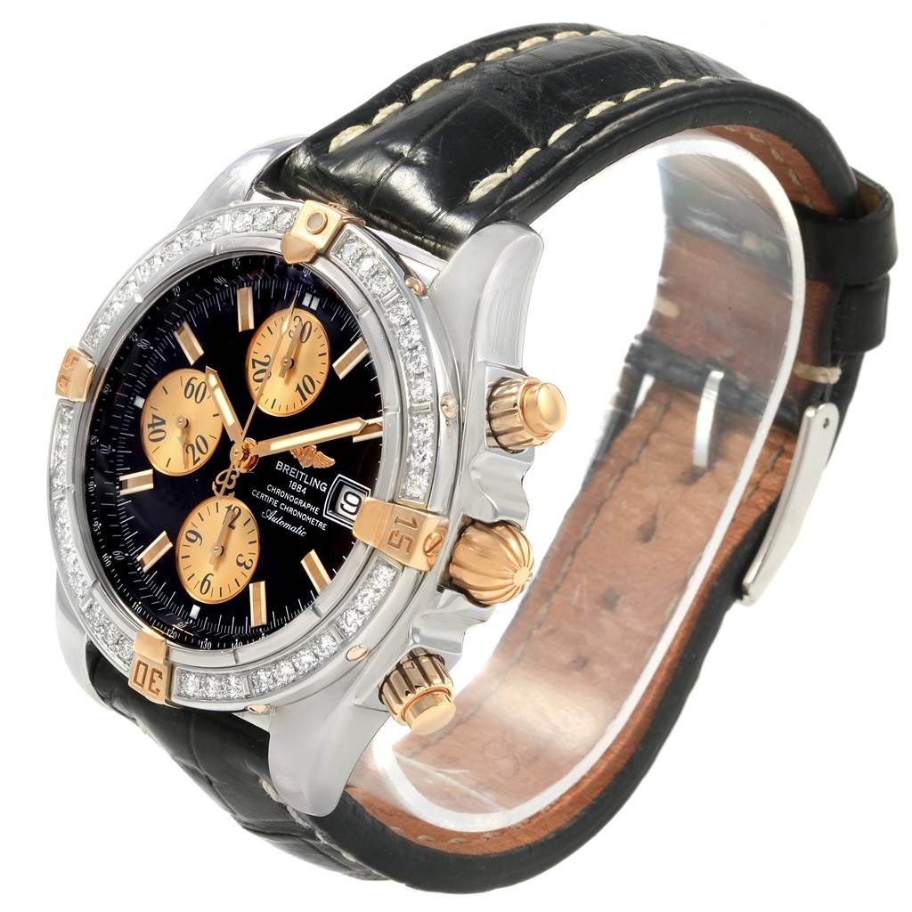 The image shows a side-angle view of the Breitling Chronomat B13356 Men's Steel and Gold (two tone) Black Dial B13356 Men's Steel and Gold (two tone) Black Dial watch, highlighting its face, band, and three crown pieces.