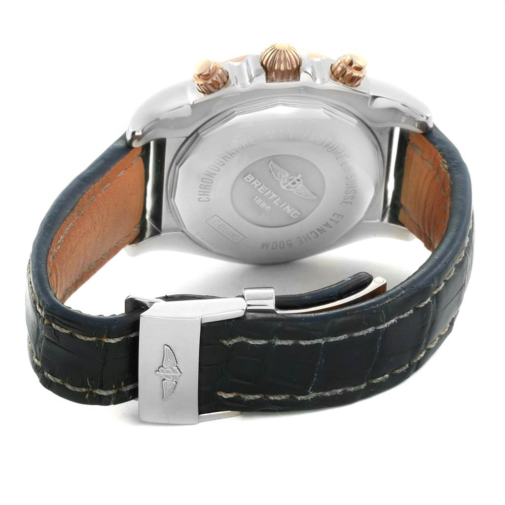The image shows the back of a Breitling Chronomat CB0110 Men
s Steel and Gold (two tone) Blue Dial CB0110 Men
s Steel and Gold (two tone) Blue Dial watch, featuring the case back, crown, pushers, and leather strap with a clasp.