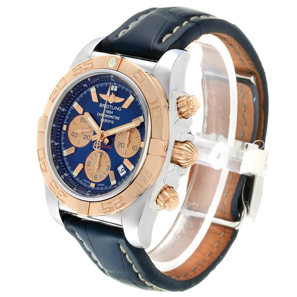 The Breitling Chronomat CB0110 Men
s Steel and Gold (two tone) Blue Dial CB0110 Men
s Steel and Gold (two tone) Blue Dial watch is viewed at a front angle, showing the face, bezel, crown, pushers, and leather strap.