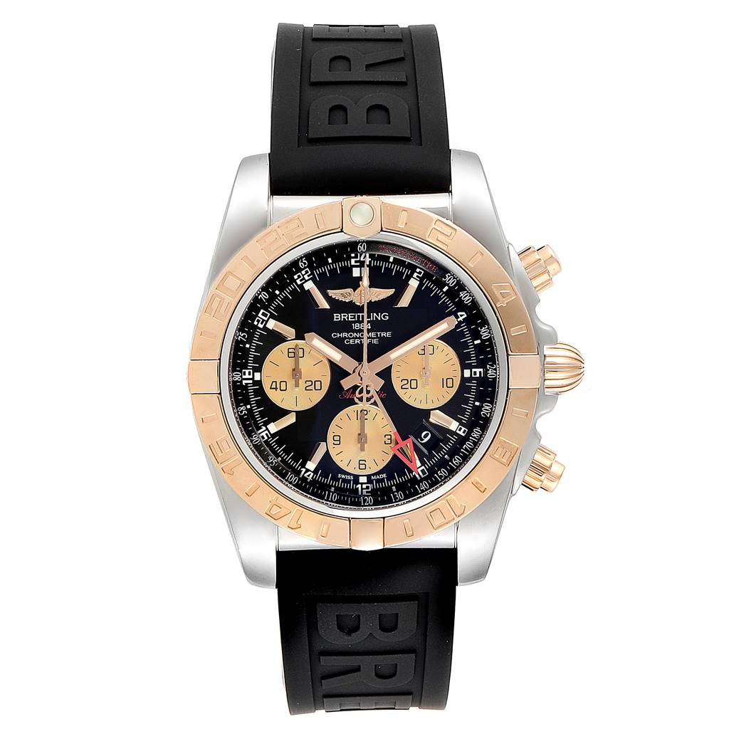 The image shows a front view of the Breitling Chronomat CB042012/BB86 Men
s Steel and Gold (two tone) Black Dial CB042012/BB86 Men
s Steel and Gold (two tone) Black Dial watch, featuring a black dial, gold subdials, and a black rubber strap.