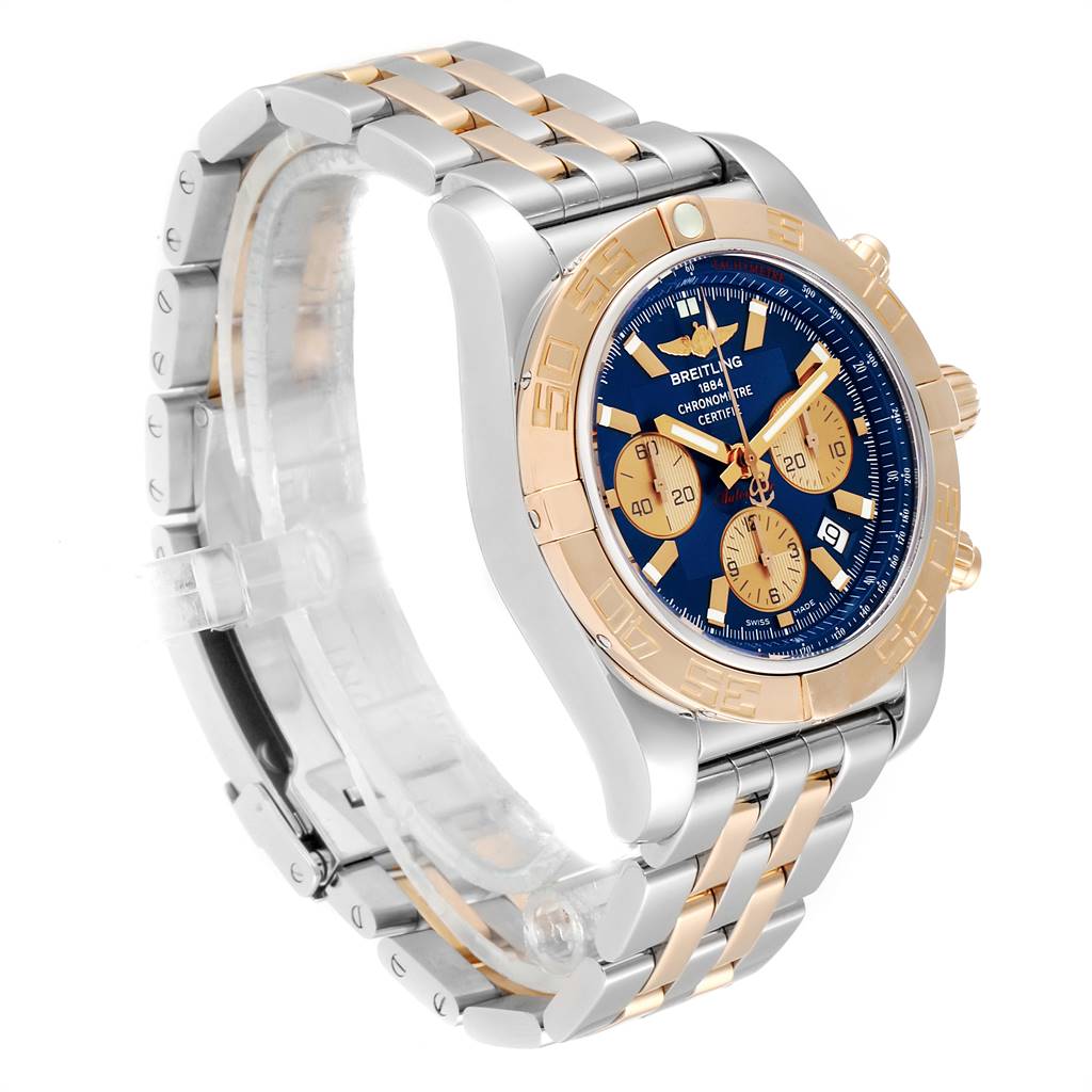 The image shows a Breitling Chronomat CB011012/C790 Men's Steel and Gold (two tone) Blue Dial CB011012/C790 Men's Steel and Gold (two tone) Blue Dial watch from a side angle, highlighting its blue dial, gold accents, and two-tone bracelet.