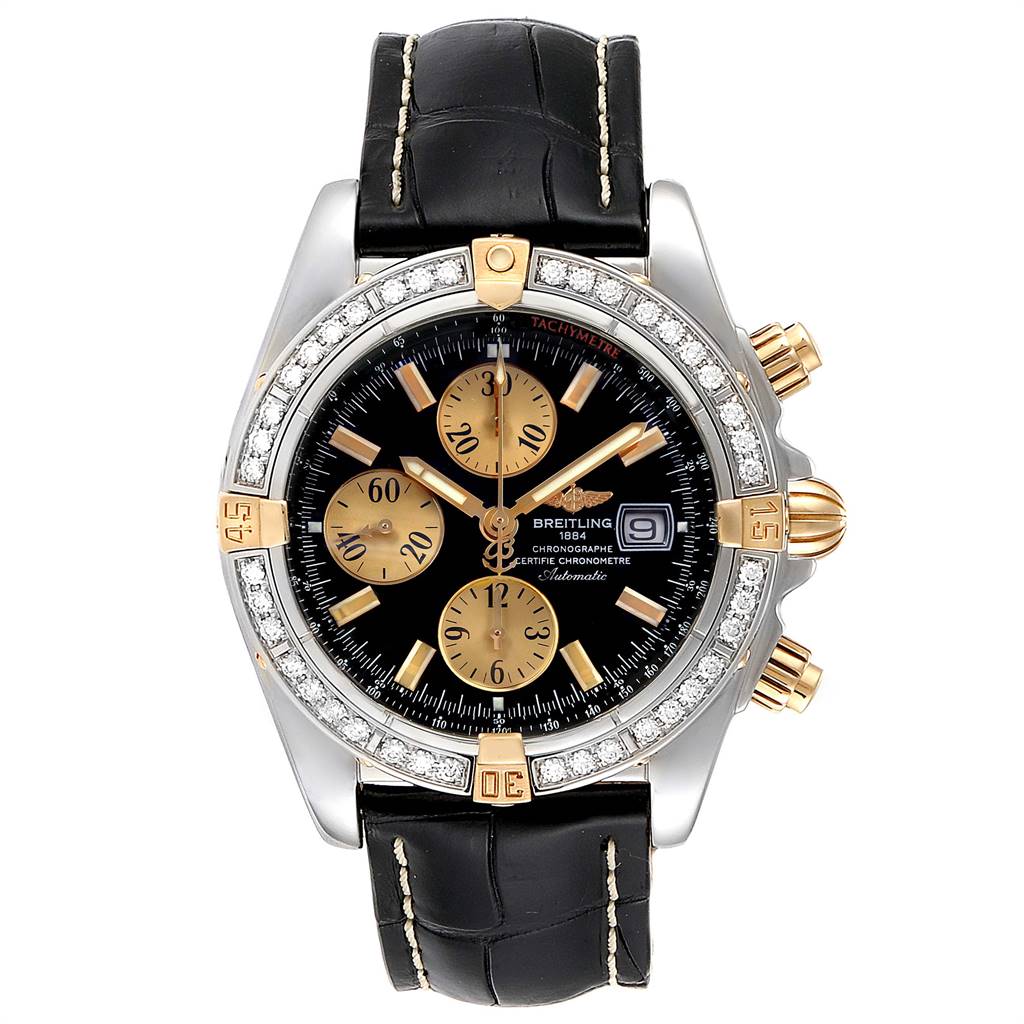 The image shows a front view of a Breitling Chronomat B13356 Men's Steel and Gold (two tone) Black Dial B13356 Men's Steel and Gold (two tone) Black Dial watch with a black leather strap and a black and gold detailed dial.