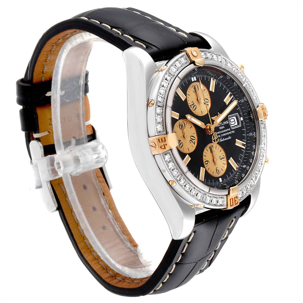 This image shows a Breitling Chronomat B13356 Men's Steel and Gold (two tone) Black Dial B13356 Men's Steel and Gold (two tone) Black Dial watch from a three-quarter angle, highlighting the face, bezel, and leather strap.