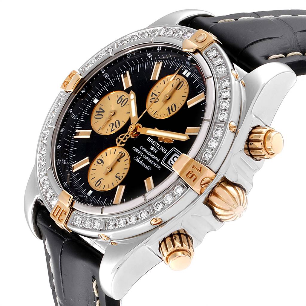 The image shows a close-up angled view of the Breitling Chronomat B13356 Men's Steel and Gold (two tone) Black Dial B13356 Men's Steel and Gold (two tone) Black Dial watch, highlighting its face, bezel, crown, and pushers.