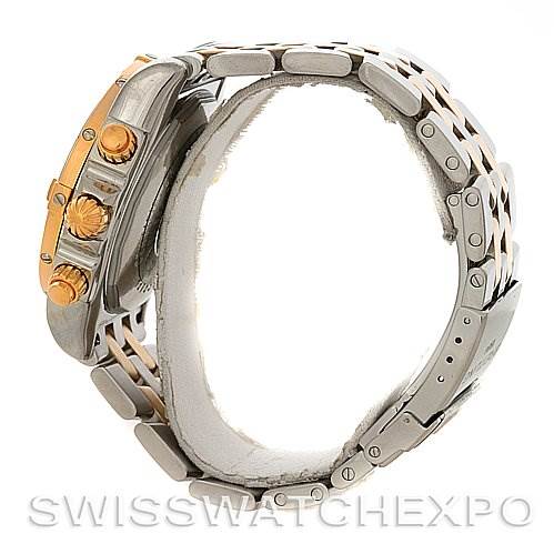 The image shows a side view of a Breitling Chronomat C1335611/K515-TT Men
s Stainless Steel Burgundy Dial C1335611/K515-TT Men
s Stainless Steel Burgundy Dial watch, highlighting its crown, pushers, and metal bracelet.