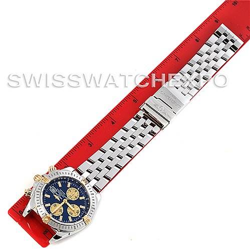 The Breitling Chronomat B1335611 Men's Steel and Gold (two tone) Blue Dial B1335611 Men's Steel and Gold (two tone) Blue Dial watch is displayed flat with its bracelet fully extended and a ruler beneath it for scale.