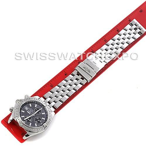 The image shows a Breitling Chronomat A1335611/F517 Men's Stainless Steel Grey Dial A1335611/F517 Men's Stainless Steel Grey Dial watch laid flat, displaying its face, bezel, and metal bracelet alongside a red ruler.