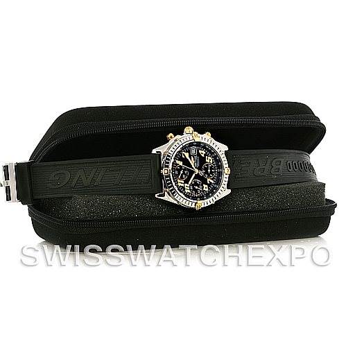 This Breitling Chronomat B13350 Men's Steel and Gold (two tone) Black Dial B13350 Men's Steel and Gold (two tone) Black Dial watch is shown from a side angle with its black rubber strap and black dial displayed, inside a black case.