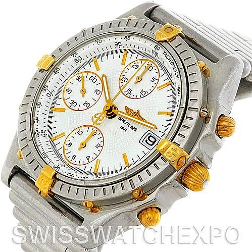 This image shows a Breitling Chronomat B13050 Men's Steel and Gold (two tone) White Dial B13050 Men's Steel and Gold (two tone) White Dial watch from an angled top view, displaying its face, bezel, crown, and pushers.