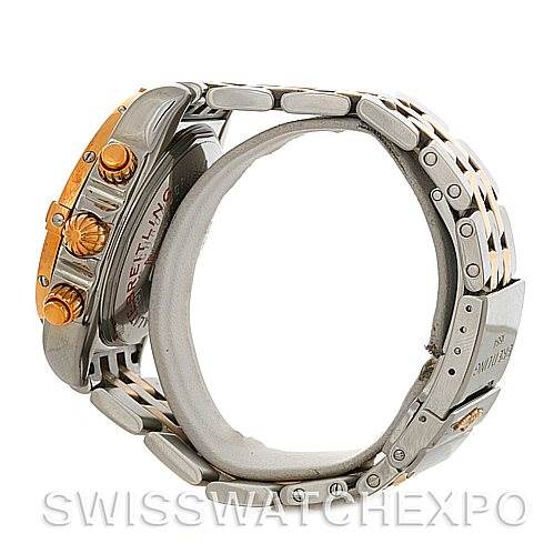 The image shows a side angle of a Breitling Chronomat C13356 Men's Steel and Gold (two tone) White Dial C13356 Men's Steel and Gold (two tone) White Dial watch focusing on its crown, chronograph buttons, and part of the bracelet.