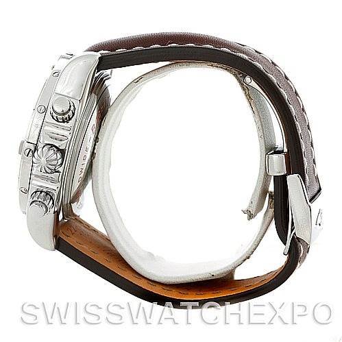 The image shows a side view of a Breitling Chronomat A13356 Men's Stainless Steel Silver Dial A13356 Men's Stainless Steel Silver Dial watch, displaying its crown, pushers, and leather strap with buckle.