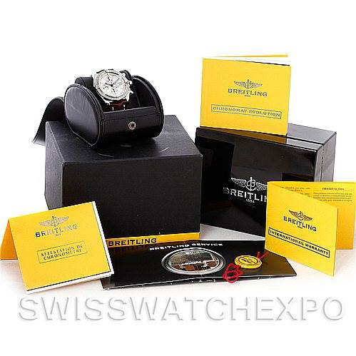 The image shows the Breitling Chronomat A13356 Men's Stainless Steel Silver Dial A13356 Men's Stainless Steel Silver Dial watch at an angle with its box and accessories, including manuals and warranty card.