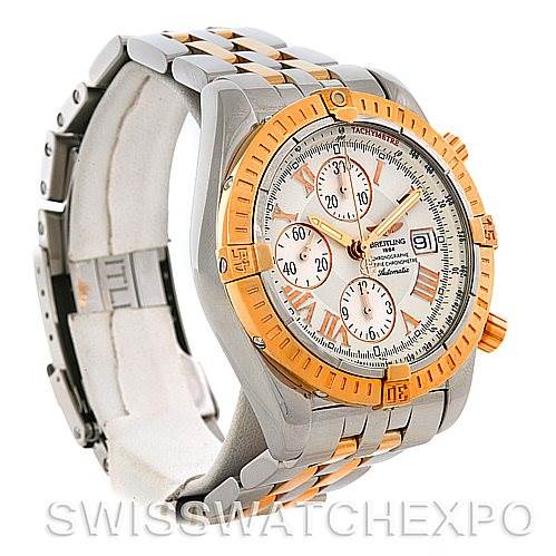 The image shows a Breitling Chronomat C13356 Men
s Steel and Gold (two tone) White Dial C13356 Men
s Steel and Gold (two tone) White Dial watch at a three-quarter angle, highlighting its stainless steel and gold bezel and bracelet.