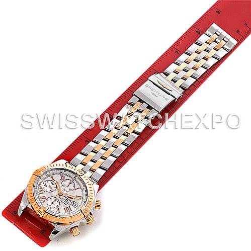 The Breitling Chronomat C13356 Men
s Steel and Gold (two tone) White Dial C13356 Men
s Steel and Gold (two tone) White Dial watch is shown laid flat with its bracelet stretched along a ruler, highlighting the face and band details.