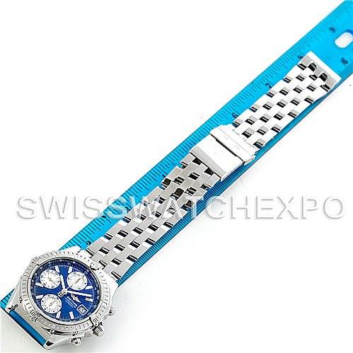 The image shows a top-down view of a Breitling Chronomat A13352 Men's Stainless Steel Blue Dial A13352 Men's Stainless Steel Blue Dial watch, displaying its silver bracelet, blue dial, and clasp against a blue measurement mat.