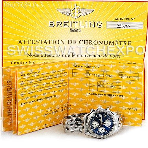 The image shows the Breitling Chronomat A13352 Men's Stainless Steel Blue Dial A13352 Men's Stainless Steel Blue Dial watch positioned in front of its warranty and certification papers.