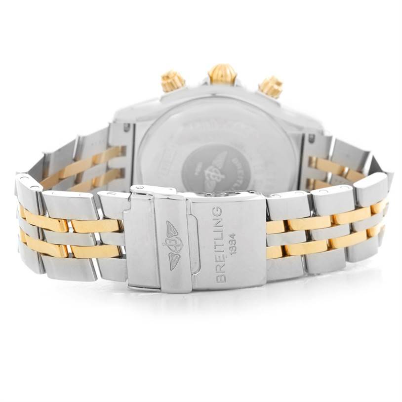 The image shows the back side of a Breitling Chronomat B13356 Men's Steel and Gold (two tone) Black Dial B13356 Men's Steel and Gold (two tone) Black Dial watch, focusing on the clasp and part of the bracelet.