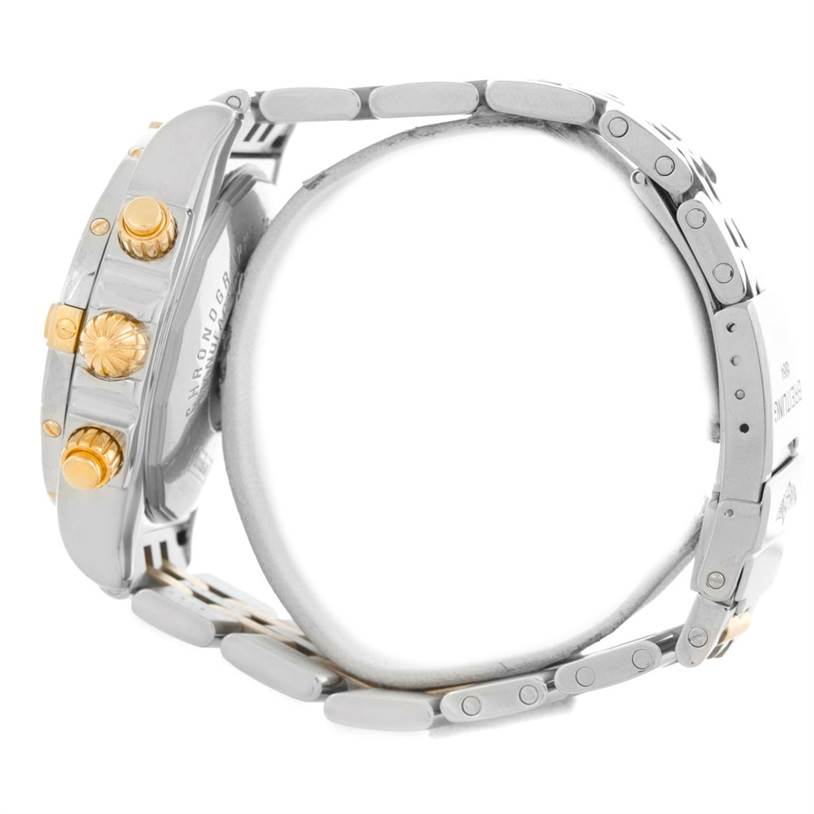 The image shows a side view of a Breitling Chronomat B13356 Men's Steel and Gold (two tone) Black Dial B13356 Men's Steel and Gold (two tone) Black Dial watch, focusing on the crown and pushers, set in a metal bracelet.