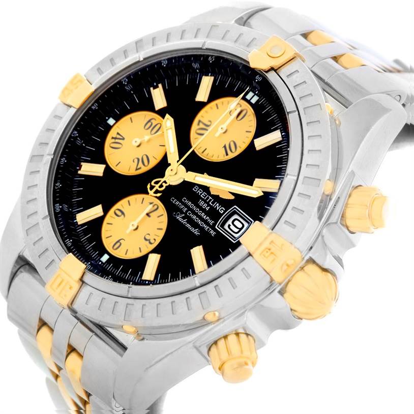 The Breitling Chronomat B13356 Men's Steel and Gold (two tone) Black Dial B13356 Men's Steel and Gold (two tone) Black Dial watch is shown partially from the front and side, highlighting its bezel, dial, and crown.