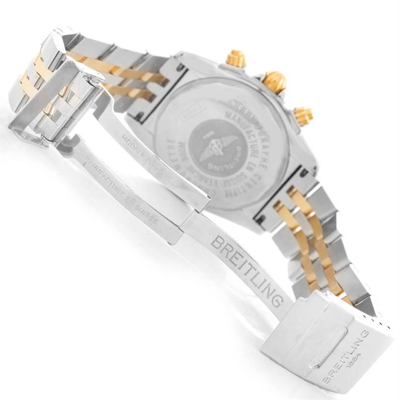 The image shows the back and clasp of a Breitling Chronomat B13356 Men's Steel and Gold (two tone) Black Dial B13356 Men's Steel and Gold (two tone) Black Dial watch, highlighting the bracelet and engraved details.