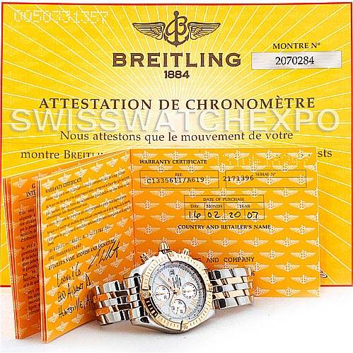 The image shows a Breitling Chronomat C13356 Men's Steel and Gold (two tone) White Dial C13356 Men's Steel and Gold (two tone) White Dial watch with its warranty certificate and chronometer attestation displayed at an angle.