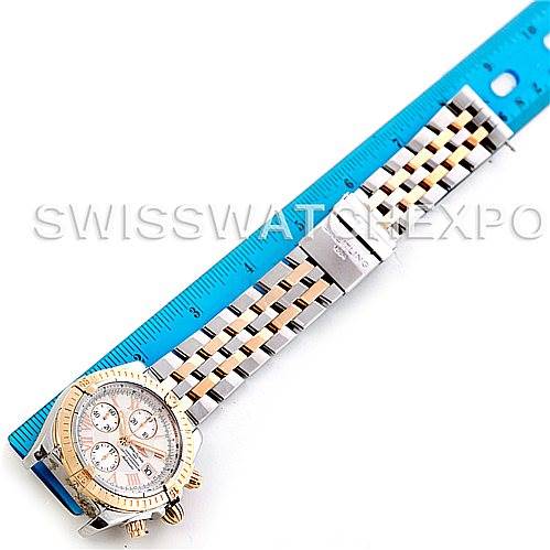 The image shows the Breitling Chronomat C13356 Men's Steel and Gold (two tone) White Dial C13356 Men's Steel and Gold (two tone) White Dial watch laid flat alongside a ruler, displaying its face and full bracelet.