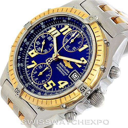 The image shows a Breitling Chronomat D13050 Men's Stainless Steel Blue Dial D13050 Men's Stainless Steel Blue Dial watch at an oblique angle, highlighting the blue dial, gold bezel, chronograph sub-dials, and two-tone bracelet.