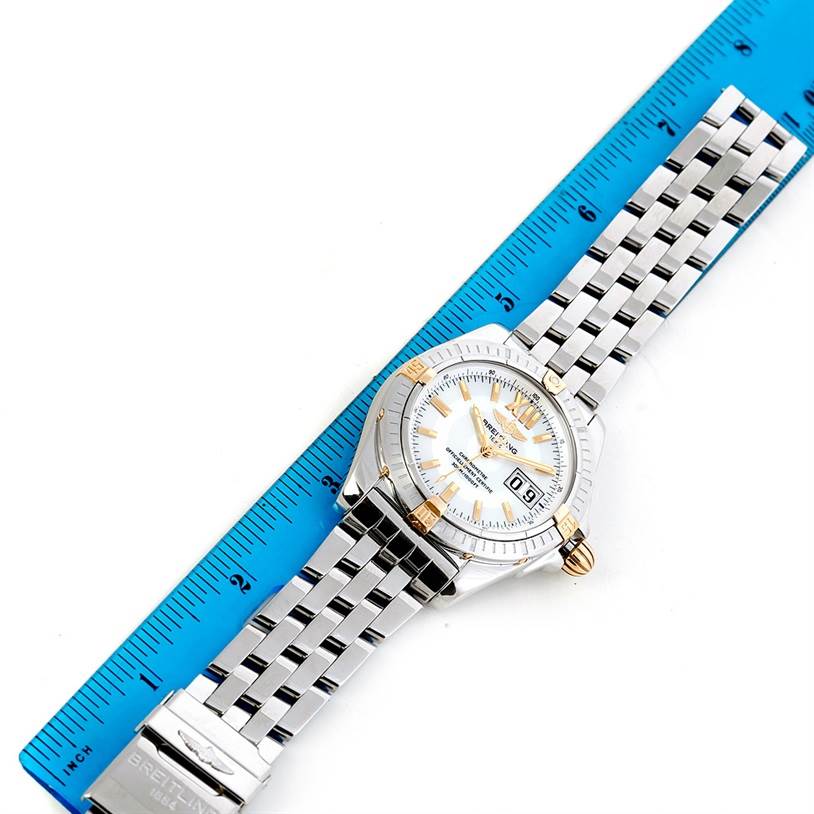 The Breitling Chronomat B49350 Men's Stainless Steel Mother of Pearl Dial B49350 Men's Stainless Steel Mother of Pearl Dial watch is shown from a top-down angle, displaying the face and full metal bracelet along with a ruler for size reference.