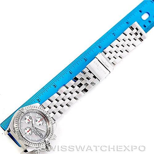 The image shows a Breitling Chronomat A13356 Men's Stainless Steel Silver Dial A13356 Men's Stainless Steel Silver Dial watch laid flat next to a blue ruler, displaying the face, bezel, and bracelet.