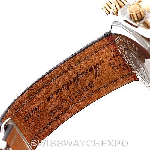 The image shows a side angle of the Breitling Chronomat C13356 Men's Steel and Gold (two tone) Burgundy Dial C13356 Men's Steel and Gold (two tone) Burgundy Dial watch, highlighting part of the leather strap and metallic case with gold tone accents.