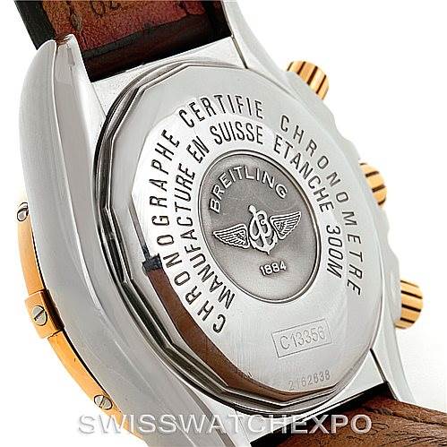 The image shows the back of a Breitling Chronomat C13356 Men's Steel and Gold (two tone) Burgundy Dial C13356 Men's Steel and Gold (two tone) Burgundy Dial watch, highlighting its engraved case back and part of the brown leather strap.